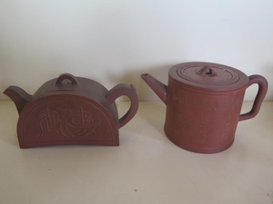 Two Chinese red ware teapots, both decorated with Chinese sc...