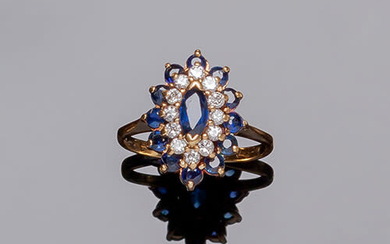 Yellow gold ring with a marquisse blue sapphire center...