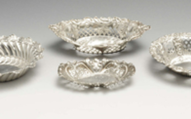 A late Victorian silver dish, plus three silver pierced dishes. (4).