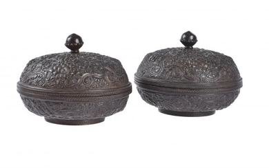 A pair of Sino-Tibetan bronze repoussé boxes and covers