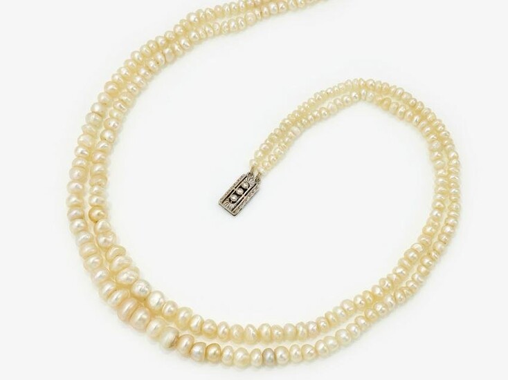 A 2-strand natural pearl necklace with a decorative