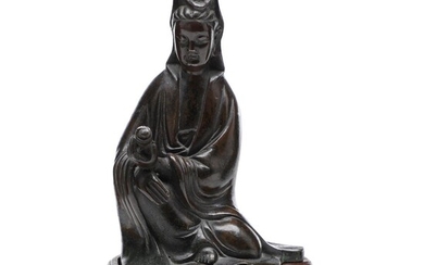 SOLD. A Chinese late Qing c. 1900 patinated bronze Guanyin. Weight 589 g. H. 16 cm. Wooden stand included. – Bruun Rasmussen Auctioneers of Fine Art
