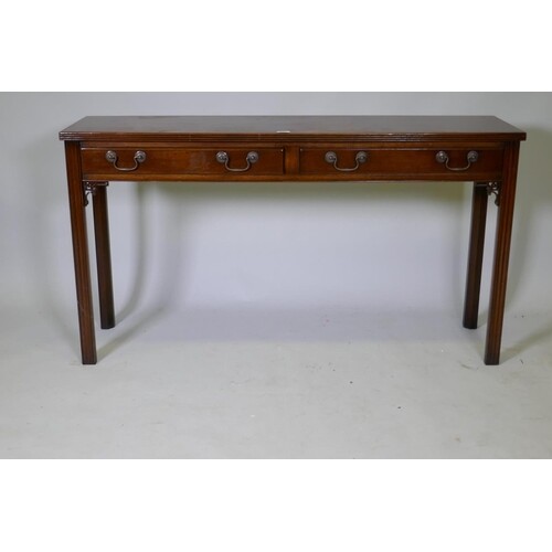 A Chippendale style two drawer mahogany side table, with ree...