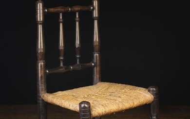 A Delightful 19th Century Rush-seated Doll's Chair with residual ebonising. The back composed of spi