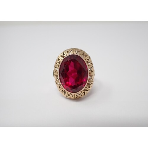 A Dress Ring rubover-set large oval-cut synthetic ruby in 18...