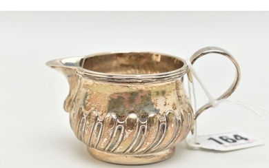 A GEORGE III SILVER CREAM JUG, stop reeded pattern, fitted w...