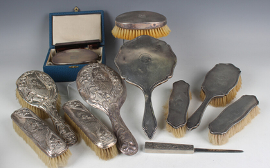 A George VI silver mounted engine turned four-piece dressing table set, comprising hand mirror, hair