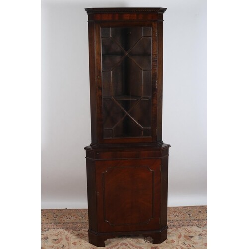 A MAHOGANY CORNER CABINET the dentil moulded cornice above a...