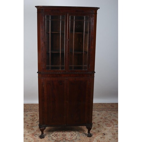 A MAHOGANY CROSS BANDED CORNER CABINET the moulded cornice a...