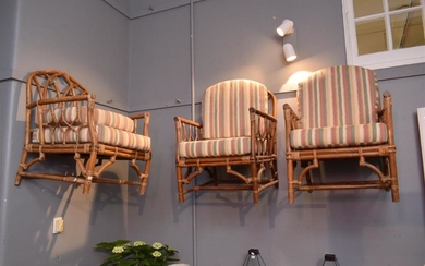 A SET OF FOUR CANE CHAIRS WITH CUSHIONS