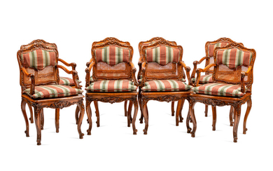A Set of Eight Louis XV Style Carved Walnut Dining Chairs