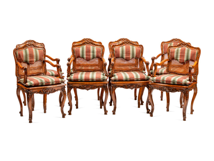A Set of Eight Louis XV Style Carved Walnut Dining Chairs
