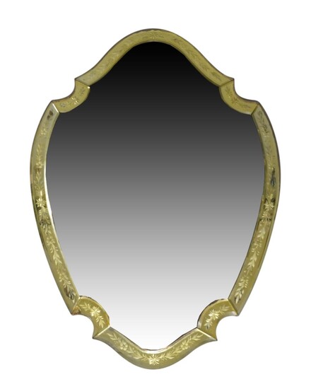 A Venetian style shield shaped wall mirror, late 20th century, with floral etched beveled border and central bevelled plate, 101cm x 70cm Provenance: The Geoffrey and Fay Elliot collection.
