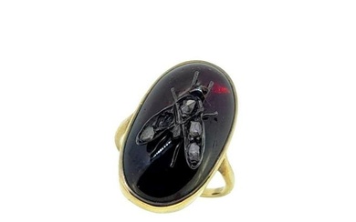 A Victorian garnet insect ring, rubover set oval shaped cabochon garnet, surmounted by a fly set