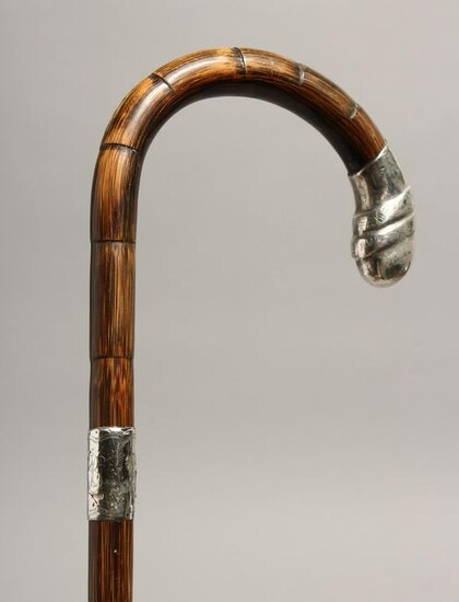 A WALKING STICK with silver handle. London 1929, 35ins