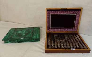 A box all in marquetry of malachite with inside a display of samples of various stones. A case with 12 English silver knives and 12 forks is attached. Period: 19th century.
