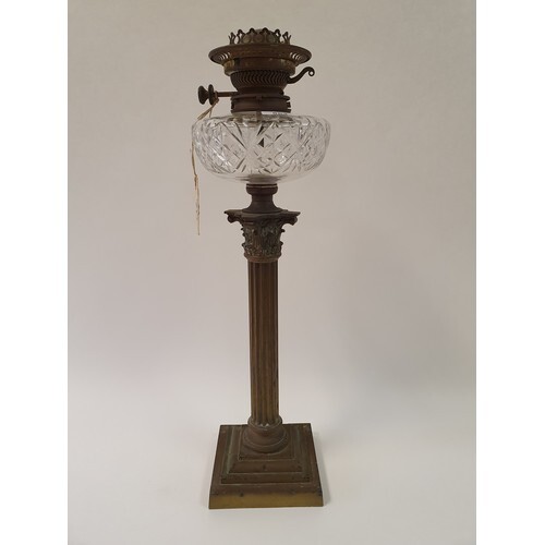 A brass oil lamp, with a cut glass well, base in form of a c...