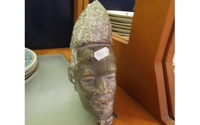 A carved soapstone African head signed to base