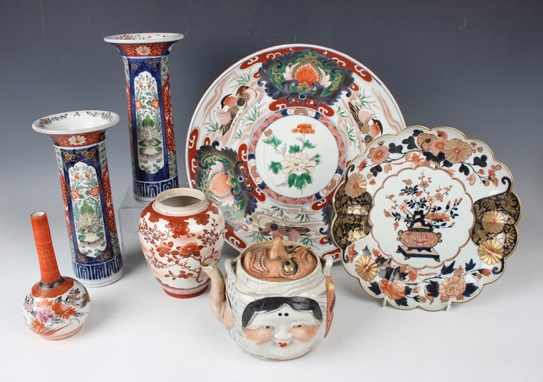 A collection of Japanese porcelain and pottery, mostly 19th century, including an Imari fluted circu