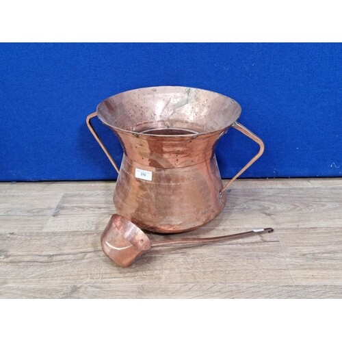A copper two handled Water Carrier with Ladle