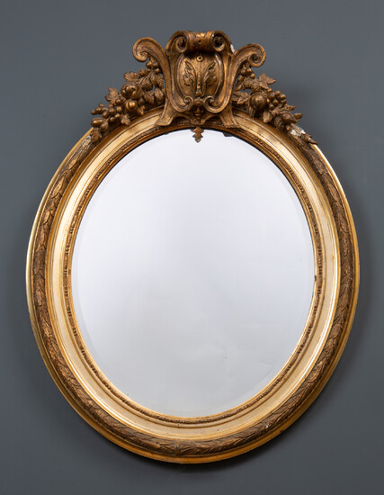 A decorative gilt oval wall mirror