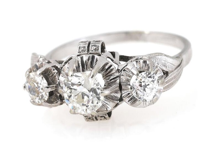 A diamond ring set with three old-cut diamonds weighing a total of...