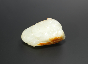 A fine white and russet jade 'lotus pond and bird' carving