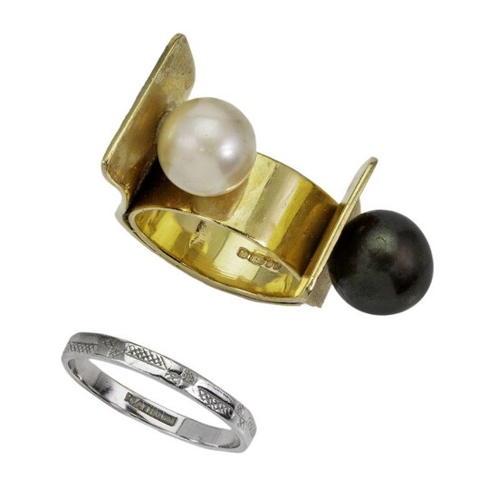 A gold and cultured pearl ring and band ring, the gold ring of flared textured design applied with a black and white cultured pearl, British hallmarks for 9-carat gold, ring size P, the band ring with engraved decoration, ring size P 1/2. (2)