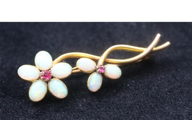 A gold floral brooch mounted with 2 rubies and 8 opals, 4.5c...