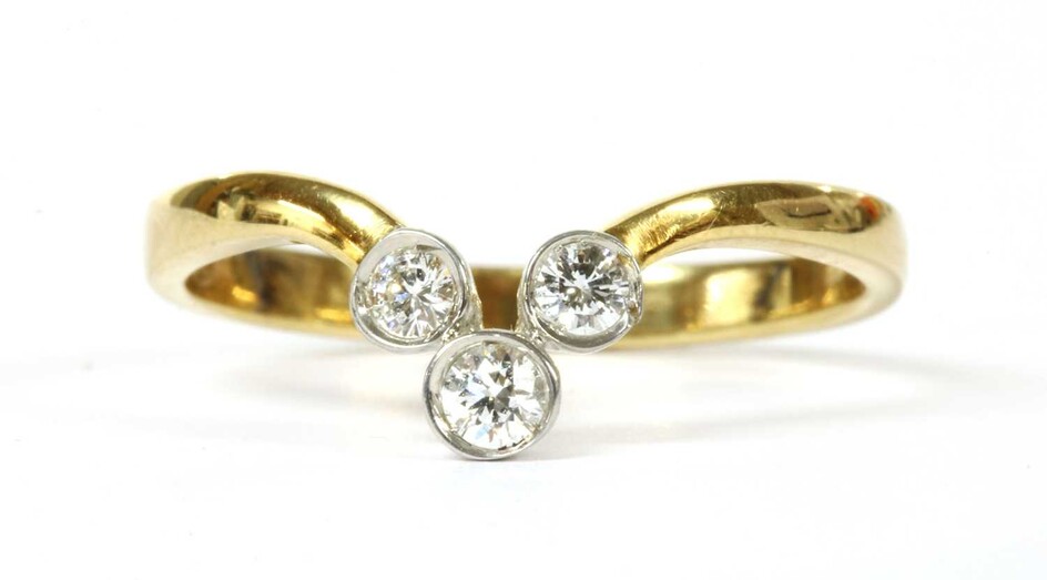 A gold three stone diamond wishbone ring