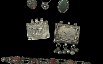 A group of Islamic and Afghan jewellery including a brass...