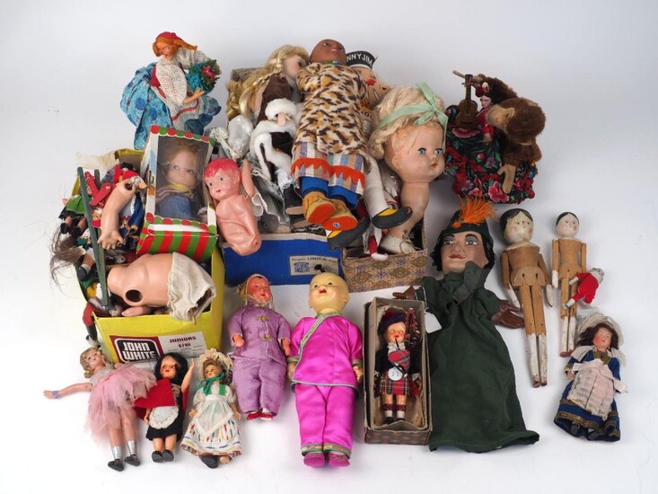 A group of dolls, 20th century and later, of varying sizes and makers, to include modern bisque head dolls in various dress, cloth dolls, peg dolls, puppets, and doll accessories (lot)