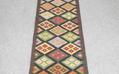 A kelim runner, with all over coloured diamond pattern, 191...
