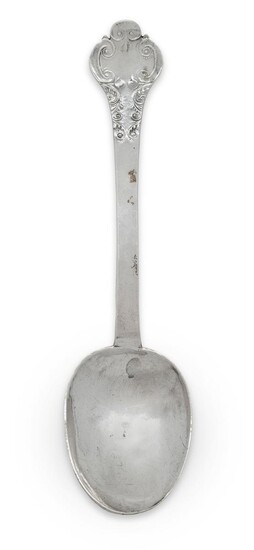 A lace-back silver trefid spoon, London, c.1685, Thomas Allen, the reverse of the terminal prick dot engraved with the initials MG over MW, the base of the stem engraved with 18th century crest, foliate scroll decoration to reverse of bowl and...