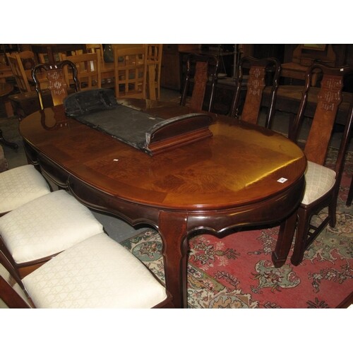 A large modern Chinese hardwood extending dining table with ...