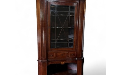 A mahogany and boxwood inlaid corner cupboard, late 18th cen...