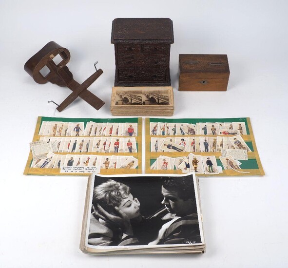 A miniature oak chest of two short over two graduating drawers on plinth base, 19cm high x 17.5cm wide, together with; a small money box, wood with two slots, a stereoscope, with a collection of slides published by J.F.Jarvis, Washington D.C to...