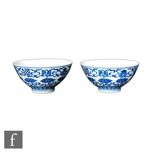 A pair of Chinese 'Buddhist emblem' blue and white bowls, Qi...