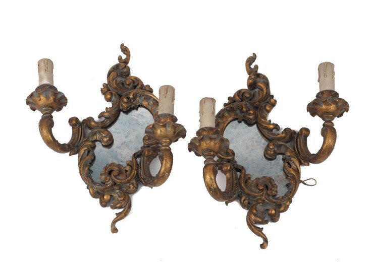 A pair of gilt wood two light wall appliques with mirrored backs, 20th century, of scrolling floral and C-scroll design, 40.5cm high, 31cm wide (2)