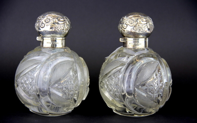 A pair of hallmarked silver topped cut glass perfume bottles, H. 13cm.