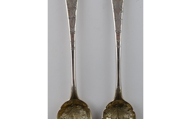 A pair of large Georgian silver spoons with embossed fruit d...