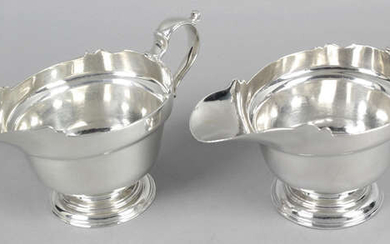A pair of silver sauce boats.