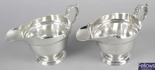 A pair of silver sauce boats.