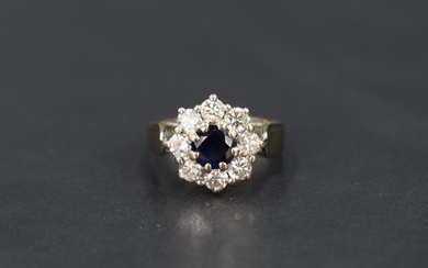A sapphire and diamond cluster ring, approx 0.5ct diamonds & 0.5ct sapphire, all in a claw set