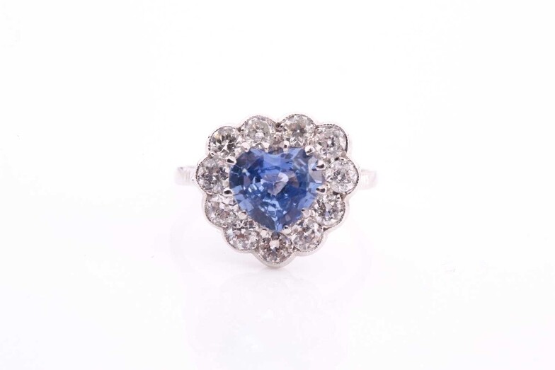 A sapphire and diamond cluster ring, set with a...