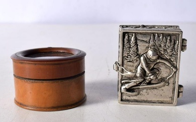 A small white metal Alpine Skier pill box together with a treen glass topped pill box 3 x 2 cm. (2)
