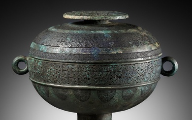 AN ARCHAIC BRONZE RITUAL FOOD VESSEL AND COVER, DOU, WITH ELEVEN BANDS OF DECORATION, LATE...