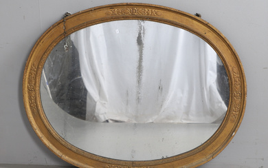 AN EARLY 19TH CENTURY OVAL MIRROR.
