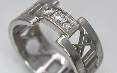 An 18K White Gold Tiffany Atlas Diamond Ring. Pierced...