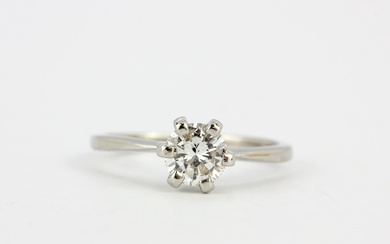 An 18ct gold and platinum solitaire ring set with a large brilliant cut diamond, approx. 0.76ct, colour - E, clarity - SI, (N).